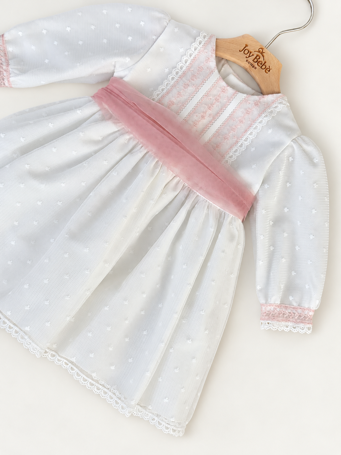 Abito Charo con fascia rosa su sfondo bianco caldo