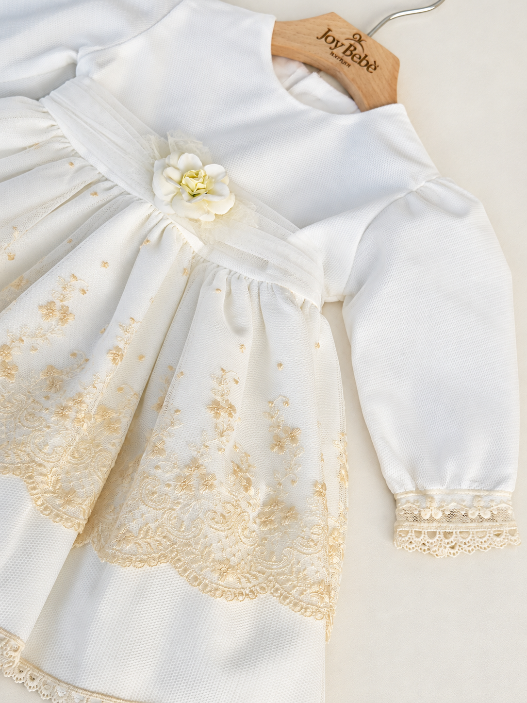 Abito Charo con ricami crema e fiore beige su sfondo bianco caldo