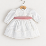 Abito Charo con fascia rosa su sfondo bianco caldo