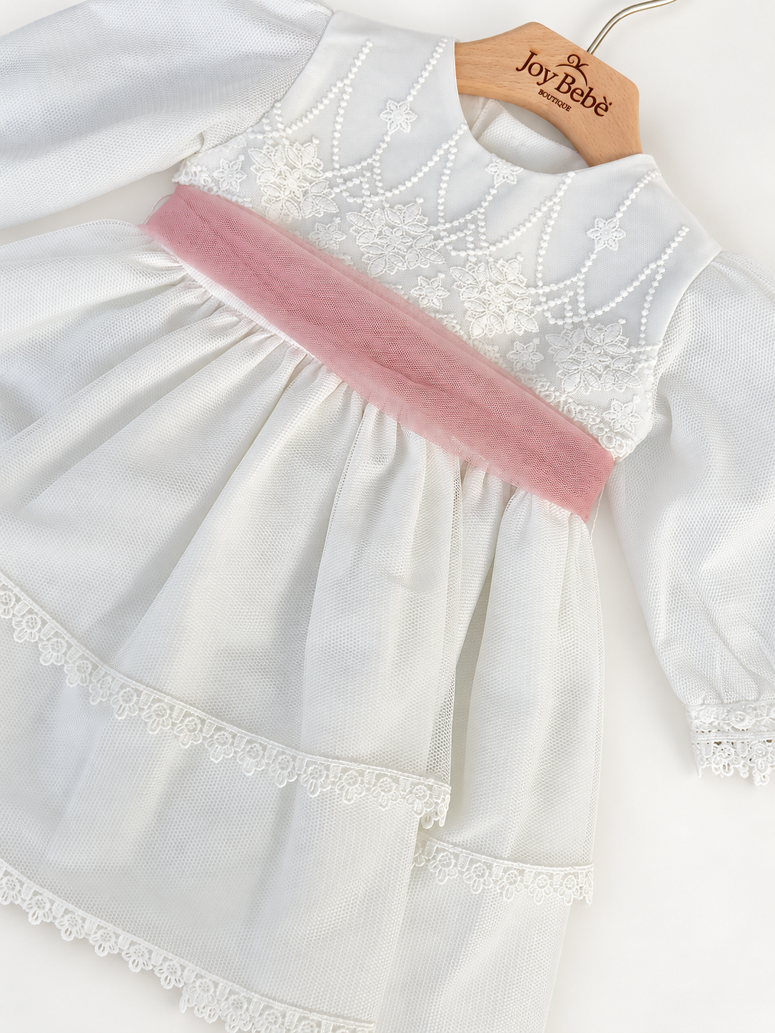 Abito Charo con fascia rosa su sfondo bianco caldo